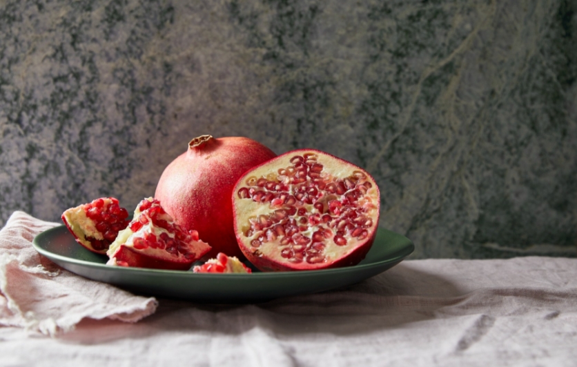 Halved pomegranate sits on platter