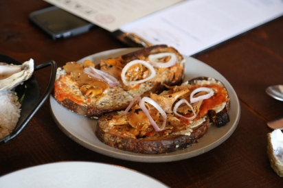 toast with tomato base topped with mushrooms and onions