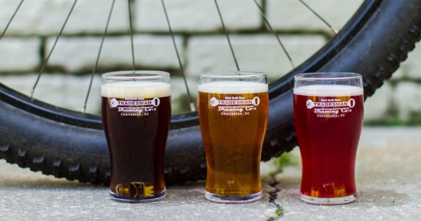 three beers in front of bike wheel 