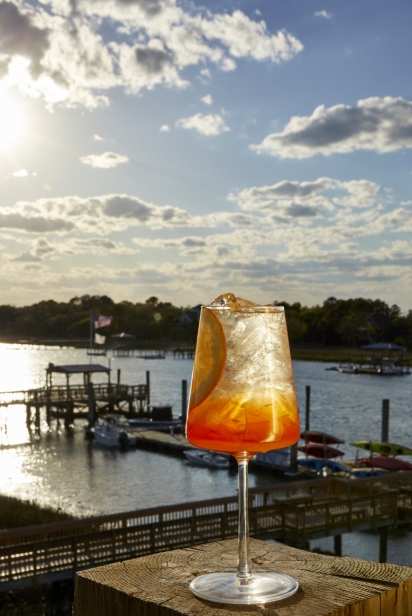 orange drink sits on a dock