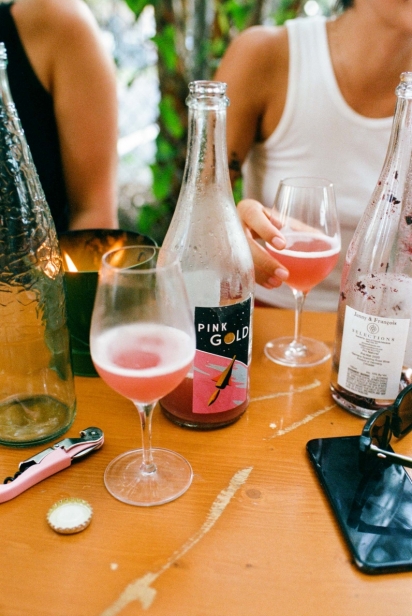 bottle of pink wine sits on a table