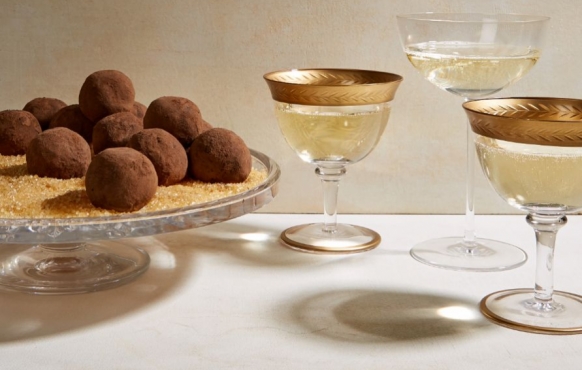 truffles on a platter next to glasses of wine 