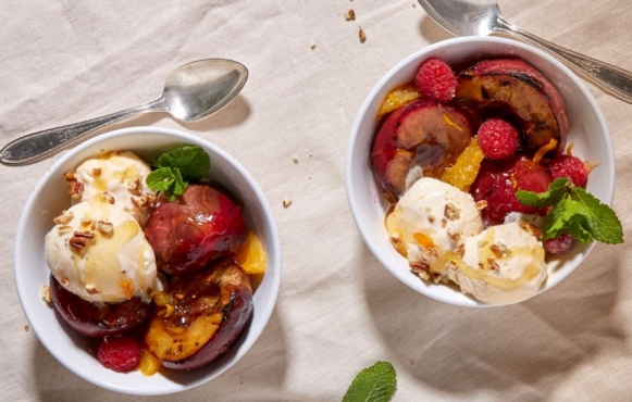 two bowls of summer fruit with vanilla ice cream 