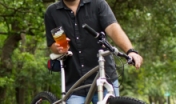 Brewer on a bike holding a beer
