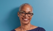 woman standing in front of blue wall